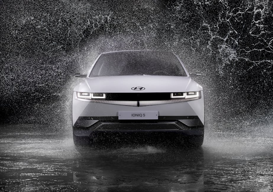 Sleek modern electric car in water spray representing auto financing
